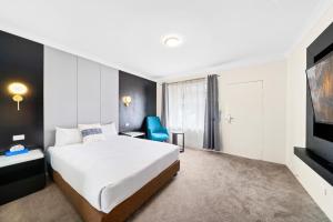 Säng eller sängar i ett rum på WM Bankstown