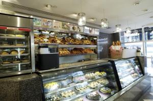 a bakery display case filled with donuts and pastries at Metropark Hotel Kowloon in Hong Kong