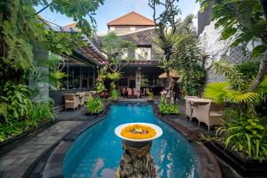 una piscina en un complejo con un tazón de comida. en The Bali Dream Villa Seminyak, en Seminyak
