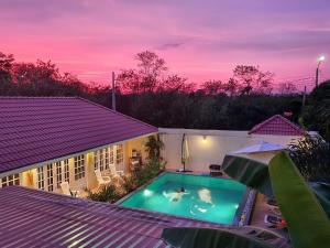 a swimming pool in the backyard of a house at Barefeet Naturist Resort in Bang Khen