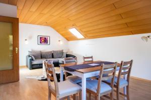 a dining room with a table and chairs and a couch at stuub simonswinkel in Friedenweiler