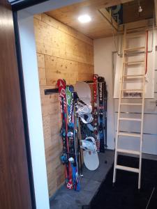 a room with a bunch of skis leaned against a wall at Burnout Wildalps in Wildalpen