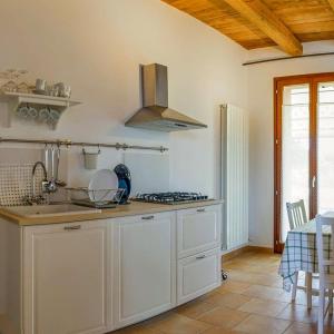 a kitchen with a sink and a stove top oven at Agriturismo Rosa Antica in Monte San Vito