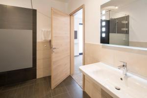 een badkamer met een wastafel en een spiegel bij Lieblingsplatz - Willingen inklusive MeineCardPlus in Willingen