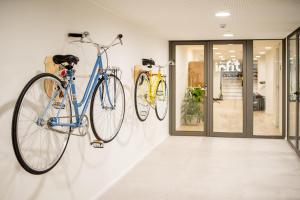 two bikes hanging on a wall in a store at INNSiDE by Meliá Zaragoza in Zaragoza