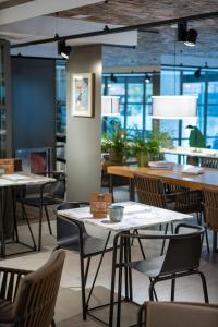 a dining room with tables and chairs in a restaurant at INNSiDE by Meliá Zaragoza in Zaragoza