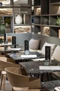 a restaurant with tables and chairs in a room at INNSiDE by Meliá Zaragoza in Zaragoza