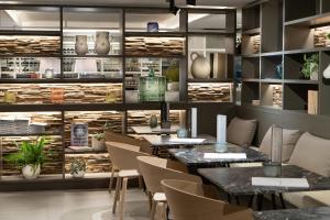 a restaurant with tables and chairs in a room at INNSiDE by Meliá Zaragoza in Zaragoza