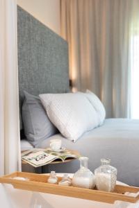 a bedroom with a bed and a tray with glass containers at INNSiDE by Meliá Zaragoza in Zaragoza
