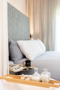 a bed with a tray with glass containers on it at INNSiDE by Meliá Zaragoza in Zaragoza
