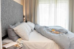 a bed with a blanket on it with a window at INNSiDE by Meliá Zaragoza in Zaragoza