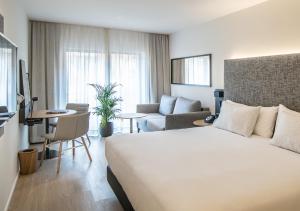 a hotel room with a bed and a living room at INNSiDE by Meliá Zaragoza in Zaragoza