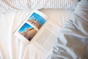 a book laying on top of a bed at INNSiDE by Meliá Zaragoza in Zaragoza