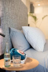 a remote control on a table next to a couch at INNSiDE by Meliá Zaragoza in Zaragoza