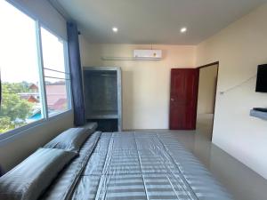Postel nebo postele na pokoji v ubytování Budchui Guesthouse