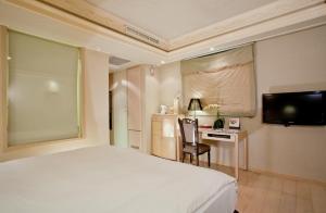Postel nebo postele na pokoji v ubytování Deja Vu Hotel
