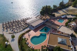 an aerial view of a resort with a swimming pool and the ocean at Vila Georgia in Siviri