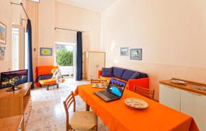 a living room with a table with a laptop on it at Casa Vacanze Parco Del Generale in Ischia