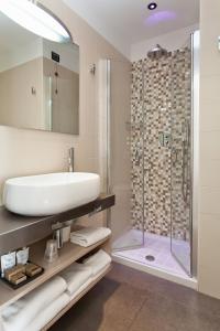 a bathroom with a sink and a shower at Hotel Adlon in Lido di Jesolo