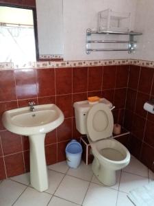 a bathroom with a toilet and a sink at Makwetu Villas in Mombasa