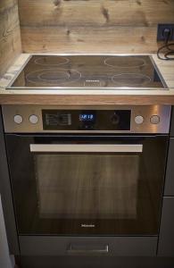 a stove top oven sitting in a kitchen at Appartements Der Fuchsbau in Saalbach-Hinterglemm