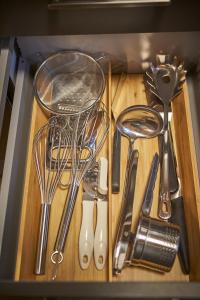 a bunch of kitchen utensils sitting on a cutting board at Appartements Der Fuchsbau in Saalbach-Hinterglemm