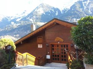 a small wooden building with mountains in the background at Les Combles des Murailles in Champéry
