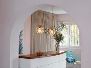 a dining room with a table and two lights at Nikis Village in Poros