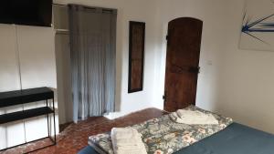 a small bedroom with a bed and a door at la bastide de l'adrech in Manosque