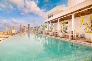 a swimming pool with a city skyline in the background at Jetwing Colombo Seven in Colombo