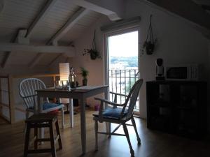 a dining room with a table and chairs and a window at Amets house in Bilbao