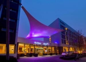a building with a purple tail on top of it at Rilano 24/7 Hotel München in Munich