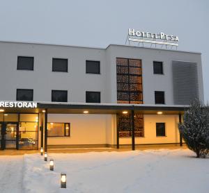 
a large building with a large window in the middle of it at Pesa Hotel in Põlva
