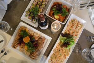
a table topped with plates of food at Pesa Hotel in Põlva
