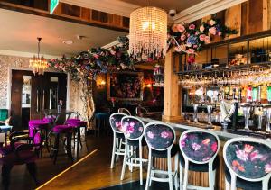 a bar with purple chairs in a restaurant at The Whistledown Hotel in Warrenpoint