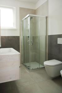 a bathroom with a shower and a toilet and a sink at Cala Blu Residence con piscina-Centralissimo Lido di Jesolo in Lido di Jesolo