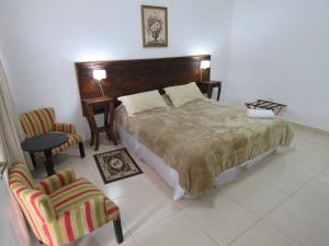 Un pat sau paturi într-o cameră la GRAN HOTEL CURUZU CUATIA