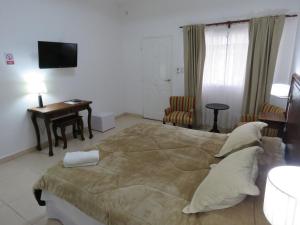 Säng eller sängar i ett rum på GRAN HOTEL CURUZU CUATIA