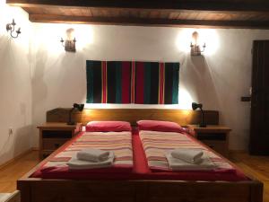 a bedroom with a bed with towels on it at Къща за гости Младата Баба in Apriltsi +38 photos