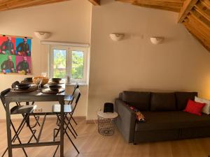 a living room with a couch and a table at Apartment2 with terrace and a view near Amoreiras in Lisbon