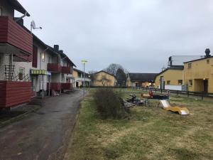 a group of buildings with a yard with a slide at Vandrarhem i Ullared in Ullared