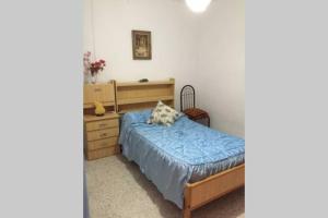 a bedroom with a bed and a dresser at Casa Lola in Montefrío
