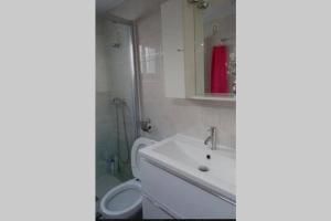 a bathroom with a sink and a toilet and a mirror at Casa Lola in Montefrío +27 photos