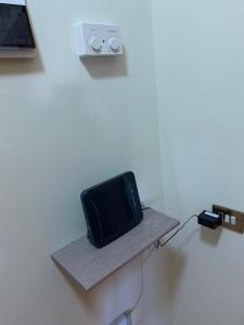 A television and/or entertainment centre at Bicocca Flat A