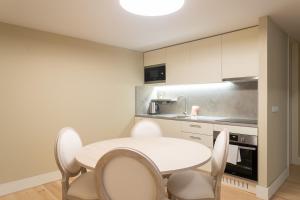 cocina con mesa blanca y sillas en FLH Cais Sodré Trendy Duplex en Lisboa
