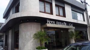 a building with a sign on the front of it at Hotel Areias Brancas in Rosário do Sul