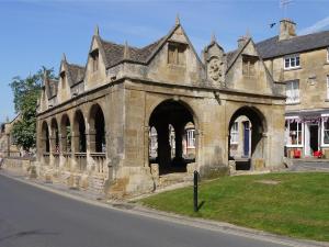 an old stone building on the side of a street at Woolmarket House in Chipping Campden