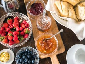 a wooden table topped with bowls of fruit and dip at Woolmarket House in Chipping Campden