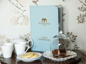 a table with a book and a plate of cookies at Woolmarket House in Chipping Campden