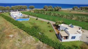 an aerial view of a house with a swimming pool at Oasea in Tavronitis